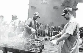  ?? BRENNEN EASTER/U.S. NAVY ?? Sailors have a “steel beach picnic” early this month on the flight deck of the aircraft carrier USS Dwight D. Eisenhower, which has been at sea since January.