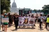  ?? Associated Press ?? This July 30 file photo shows supporters of the family of slain Army Spc. Vanessa Guillen march to the White House along the National Mall as Capitol Hill is seen in the distance after a news conference in Washington. The death of Guillen, who was slain by a fellow soldier at the Texas Army base where they both worked, has been classified as “in the line of duty,” according to a report by U.S. Army officials. The results were presented to the Guillén family on Wednesday.