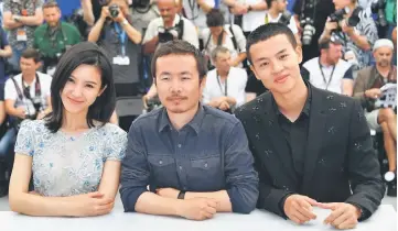  ??  ?? (From left) Actress Yang Zishan, director Li Ruijun and actor Yin Fang during a photocall for the film ‘Walking Past the Future’ in Cannes. — AFP photo