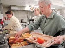  ?? THE HAMILTON SPECTATOR FILE PHOTO ?? In this file photo, volunteers serve hot breakfasts at the Wesley Centre’s Christmas event. Dave Davis discusses and reflects on the act of volunteeri­ng.