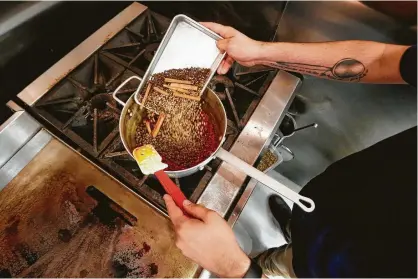  ?? Steve Gonzales / Houston Chronicle ?? Spices are toasted and cooked in fat before being puréed into a paste to make cochinita pibil.