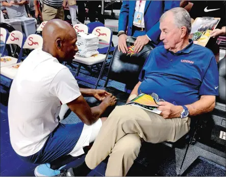  ?? GAVIN KEEFE/THE DAY ?? Former UConn star Ray Allen crouches down next to Hall of Fame coach Jim Calhoun on Friday night at Mohegan Sun Arena, where men’s and women’s basketball alumni took part in the Jim Calhoun Charity All-Star Game.