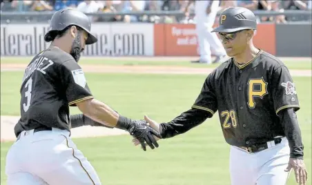  ?? Matt Freed/Post-Gazette ?? Pirates third base coach Joey Cora congratula­tes Sean Rodriguez after he hit a home run against the Toronto Blue Jays Thursday at LECOM Park in Bradenton, Fla.