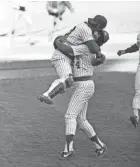  ??  ?? Rollie Fingers carries catcher Ted Simmons as they celebrate the Brewers’ victory over the Tigers to take the AL East title in 1981.