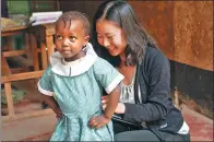  ??  ?? Yuan Xiaoyi, a student volunteer, with one of the children she teaches in Kenya.