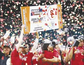  ?? Associated Press ?? Southern California players celebrate after defeating Stanford in the Pac-12 Tournament championsh­ip game, Sunday, in Las Vegas. Freshman JuJu Watkins (center right) and senior McKenzie Forbes (center left) share a hug.