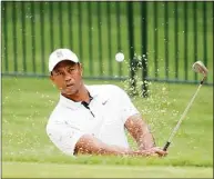  ?? Christian Petersen / Getty Images ?? Tiger Woods plays a shot out of the bunker during a practice round Tuesday before the PGA Championsh­ip at Southern Hills Country Club in Tulsa, Okla.