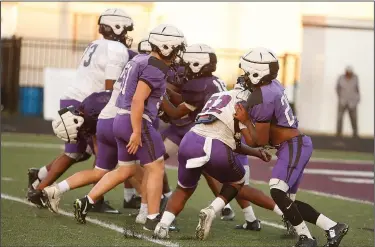  ?? Terrance Armstard/News-Times ?? Pushing and shoving: El Dorado's linemen go through drills during football practice Wednesday night at Memorial Stadium. Coach Scott Reed said the team will put on full pads for practice on Monday.