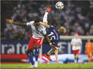  ??  ?? Down to earth...Khaled Narey (left) and hamburg lose at home to Johannes Van den Bergh’s holstein Kiel in 2.Bundesliga