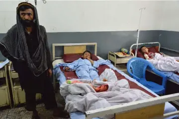  ??  ?? Wounded children receive medical treatments at a hospital following an explosion, in Mihtarlam city the capital of Laghman province. — AFP photo