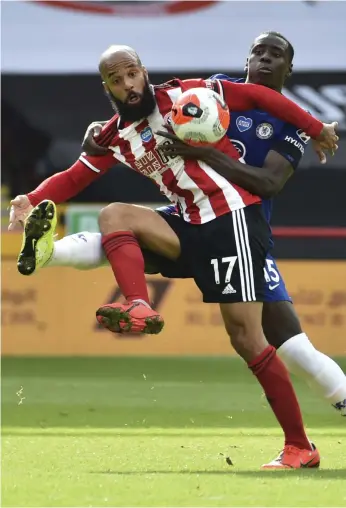  ?? AP ?? Sheffield United’s David McGoldrick fights for the ball while holding off Chelsea’s Kurt Zouma at Bramall Lane. McGoldrick scored his first two goals of the season for the hosts