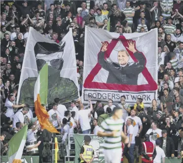  ??  ?? 0 Celtic fans display a paramilita­ry IRA banner which has resulted in disciplina­ry action by Uefa.