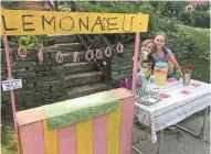  ?? SUBMITTED ?? Abby Sumka, 9, and her brother Bennett,7, hold a lemonade stand to raise money for neighbor McKinley Sovey's eye surgeries. Lawmakers in the state Senate voted Tuesday to legalize lemonade stands for children.