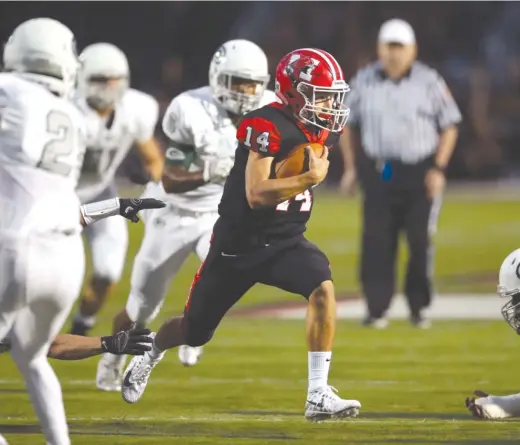  ?? KEVIN TANAKA/FOR THE SUN-TIMES ?? Maine South quarterbac­k Bobby Inserra runs for a first down Friday against Glenbard West in Park Ridge. He ran for 140 yards and a touchdown.