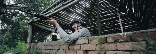  ?? ANJUM NAVEED/ THE ASSOCIATED PRESS ?? A Pakistani soldier monitors the India- Pakistan border which has been the scene of renewed violence. Awarding the Nobel Peace Prize jointly to an Indian and Pakistani won’t change much, analysts say.