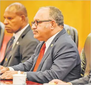  ?? FRED DUFOUR/Pool via REUTERS ?? Former Papua New Guinea Prime Minister Peter O’Neill has called on the National Government to review the tax laws to give relief to workers to live through the recession facing the country. Picture: