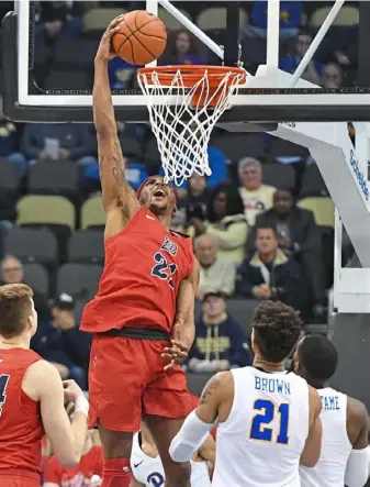  ?? Peter Diana/Post-Gazette photos ?? Center Michael Hughes dunks against Pitt in the first half, but the Panthers righted the ship in the second half. Hughes had 20 points and 10 rebounds for the Dukes.