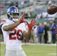  ??  ?? BILL KOSTROUN — THE ASSOCIATED PRESS New York Giants running back Saquon Barkley (26) warms up before an NFL football game against the New York Jets, Friday in East Rutherford, N.J.