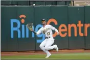  ?? JEFF CHIU — THE ASSOCIATED PRESS ?? A’s left fielder Luis Barrera (13) catches a flyout hit by the Red Sox’s Rafael Devers during the fifth inning on Saturday in Oakland.