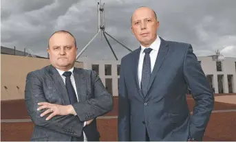  ?? Picture: GARY RAMAGE ?? TOUGH STANCE: Home Affairs Minister Peter Dutton and Victorian MP and former police officer Jason Wood in front of Parliament House.