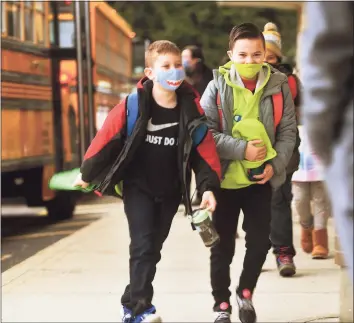  ??  ?? Students return to school after two months of remote home instructio­n at Long Hill Elementary School on Monday.