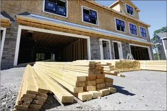  ?? ELISE AMENDOLA — THE ASSOCIATED PRESS ?? A constructi­on site in Middleton, Mass. Rising costs and shortages of building materials and labor are rippling across the homebuildi­ng industry, which accounted for nearly 12% of all U.S. home sales in July.