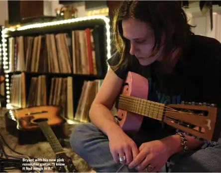  ??  ?? Bryant with his new pink resonator guitar. “I knew it had songs in it.”