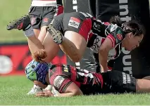  ?? GETTY ?? Canterbury wing Martha Mataele dives under a tackle to score yesterday in Pukekohe.