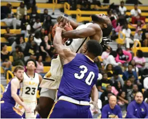  ?? (Pine Bluff Commercial/I.C. Murrell) ?? UAPB’s Rashad Williams is tied up by Andre Nunley of Prairie View A&M during the first half at H.O. Clemmons Arena on Saturday.