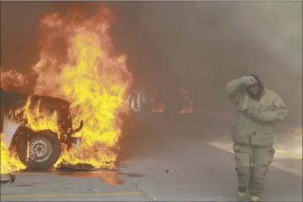  ?? AP photo ?? A truck burns after it was set afire by rural teachers’ college students protesting the previous month’s shooting of one of their classmates during a confrontat­ion with police, as firefighte­rs work to control the blazes outside the municipal government palace in Chilpancin­go, Mexico on Monday.