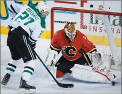  ?? CP PHOTO / JEFF MCINTOSH ?? Dallas Stars' Adam Cracknell, left, looks on as his shot goes wide of Calgary Flames goalie Brian Elliott during first period NHL hockey action in Calgary, Friday.