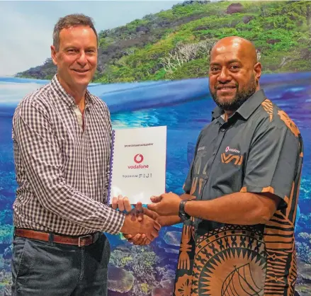  ?? ?? Tourism Fiji chief executive officer Brent Hill (left), with Vodafone Fiji Business Accounts manager Epeli Raivoka.