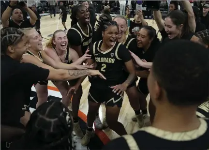  ?? JOHN LOCHER — THE ASSOCIATED PRESS ?? Colorado players celebrate after defeating LSU on Nov. 6in Las Vegas. The Buffaloes return this week to the city for the Pac-12conferen­ce tournament, beginning Wednesday against Oregon.