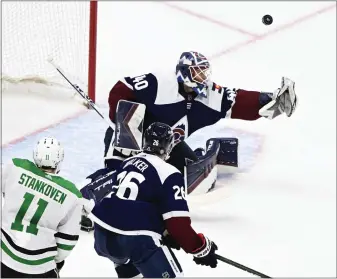  ?? ANDY CROSS — THE DENVER POST ?? Avalanche goaltender Alexandar Georgiev deflects a shot while Dallas center Logan Stankoven looks for a rebound and Colorado defenseman Sean Walker defends at Ball Arena on Sunday.