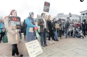  ??  ?? &gt; People in Birmingham at a rally supporting Syrian refugees