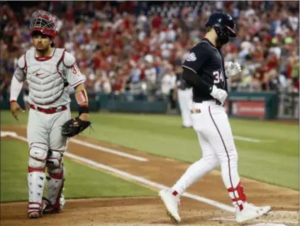  ?? PABLO MARTINEZ MONSIVAIS — THE ASSOCIATED PRESS ?? Washington Nationals’ Bryce Harper, right, steps past Phillies catcher Jorge Alfaro and crosses home after hitting a two-run home run off starting pitcher Nick Pivetta during the second inning Friday night at Nationals Park.