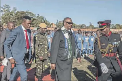  ?? Photos: Amos Gumulira/afp, Ken Jack/corbis/getty Images, and Facebook ?? The president’s man: (from top) Former Malawian president Peter Mutharika (centre) and his bodyguard Norman Chisale (left) at independen­ce anniversar­y celebratio­ns in 2018; Mutharika (front) and Chisale (back right) during a visit to the Scottish parliament; and Chisale after appearing in court.