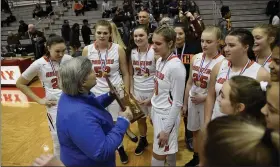  ?? PAUL DICICCO — FOR THE NEWS-HERALD ?? North is awarded the district championsh­ip trophy after defeating Brush on Feb. 28at Perry.