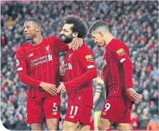  ??  ?? Wijnaldum and Firmino congratula­te Salah on his first goal