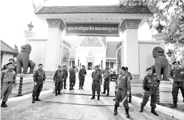  ??  ?? Police officers stand guard at the Supreme Court during a hearing to decide whether to dissolve the main opposition Cambodia National Rescue Party (CNRP), in Phnom Penh, Cambodia. — Reuters photo