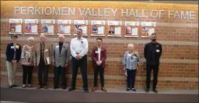  ?? PHOTO COURTESY OF PERKIOMEN VALLEY SCHOOL DISTRICT ?? The first class of inductees into the Perkiomen Valley School District Hall of Fame are seen standing near their plaques. From left to right are Joanne (Kehs) Conte, Mary Fenstermac­her, Bill Fretz, Dr. Franklin Manley, Bill Neill, Steven Rich, Jacki Trankle, and Grant Wiley. Dave Roberts was unable to attend the ceremony and is not pictured.