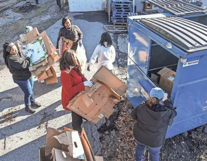  ?? KEN RUINARD/GREENVILLE NEWS ?? Volunteers recycle cardboard in Anderson on Jan. 13.