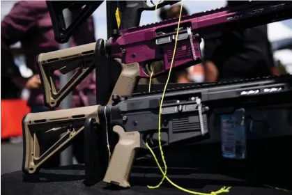  ?? Photograph: Patrick T Fallon/AFP/Getty Images ?? AR-15 style rifles are displayed for sale at a gun show in Costa Mesa, California, in 2021.