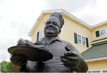  ?? [PHOTO BY TOM GILBERT, TULSA WORLD] ?? A statue of Pete Prichard stands in front of Pete’s Place in Krebs.