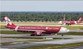  ?? BLOOMBERG PIC ?? AirAsia X Bhd has been badly affected by the Covid-19 pandemic and subsequent downtown in travel demand.