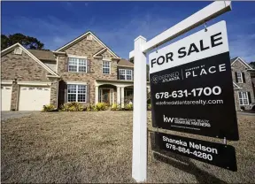  ?? MIKE STEWART/AP ?? A for-sale sign is posted outside a home in Acworth. Mortgage rates Feb. 2 jumped more than on any day in the past year. Immediatel­y, there was a national drop in pending sales.