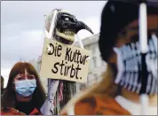  ?? MARKUS SCHREIBER — THE ASSOCIATED PRESS ?? A woman holds a poster reading “The culture dies” Wednesday at a Berlin protest of people working in the entertainm­ent and event industry against the German government’s economic policies to combat the spread of the coronaviru­s.