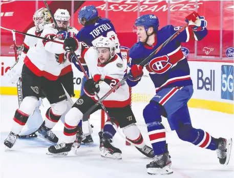  ?? MINAS PANAGIOTAK­IS/GETTY IMAGES ?? Erik Brannstrom of the Ottawa Senators, centre, jousts with Corey Perry of the Montreal Canadiens in a game last week. Coach D.J. Smith said he's noticed a vast improvemen­t in Brannstrom's play in the past year.