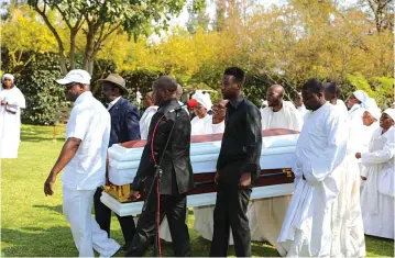  ?? ?? Informatio­n,Publicity and Broadcasti­ng Services Permanent Secretary Mr Nick Mangwana (in white cap) and other pallbearer­s carry the casket of the late Gogo Sabina Mangwana during a church service in Kwekwe yesterday