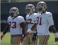  ?? JEFF CHIU — THE ASSOCIATED PRESS ?? From left, the 49ers’ D.J. Jones, Nick Bosa and Arik Armstead participat­e in practice Monday in Santa Clara.